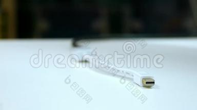 为<strong>苹果</strong>公司充电的USB电源线放在白色桌子上，<strong>充电器</strong>